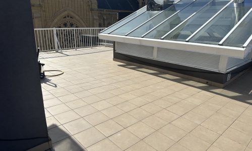 Terraza con suelo de azulejos y barandilla, vista despejada del cielo